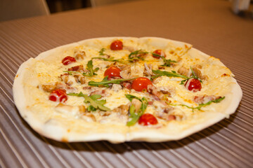 Delicious pizza with arugula and cherry tomatoes