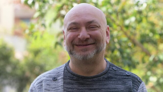 bald mature man looking at camera and smiling - hope, joyful