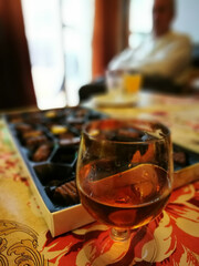 Obraz na płótnie Canvas Time to relax. Glass of brandy and box of delicious chocolates stuffed.