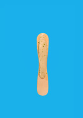 popsicle stick with a little bit left of on blue background