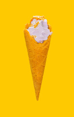 angle view sweet potato flavor ice cream cone with some bites on yellow background