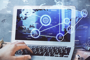 Media network theme hologram with man working on computer on background. Concept of internet...