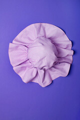 Tender pink hat for women, girls or baby on a trendy background. Stylish hat for the beach and travel.