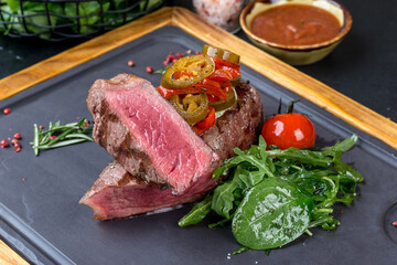 Sliced steak with fresh herbs and vegetables