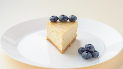 Slice of New York Cheesecake on white plate