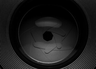 The diaphragm of a camera lens aperture. Selective focus with shallow depth of field. Color toned image