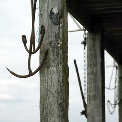 Old rusted anchors hanging on lifeguard tower