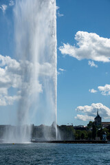 sky with big clouds and water jet in geneva, switzerland