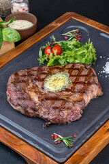 Grilled steak served on a black slate board