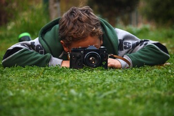 A vintage camera with a kid playing with it 