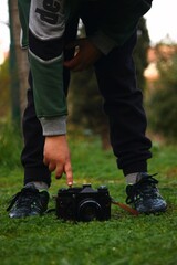 A vintage camera with a kid playing with it 