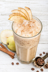 One transparent, glass cup of cold coffee