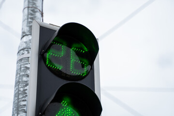 Green trafic light in the city in a daylight.