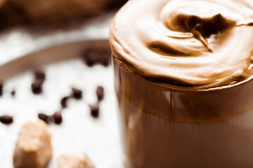 close up view of delicious Dalgona coffee in glass with foam