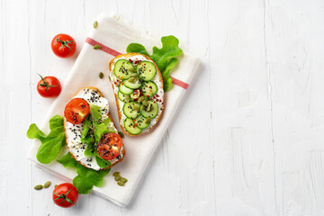 Sandwiches with cheese feta, cucumber slices and cherry tomatoes. View from above