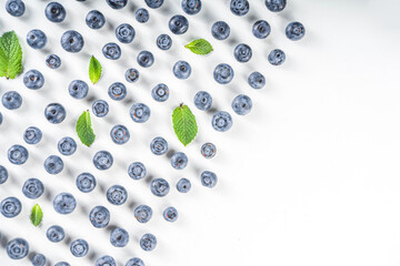 Flatlay pattern with fresh ripe blueberries on white background