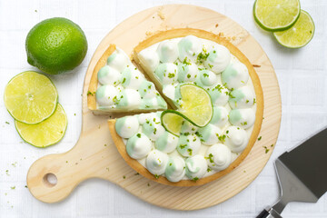 key lime cheese tart with whipping cream on the table, horizontal view from above