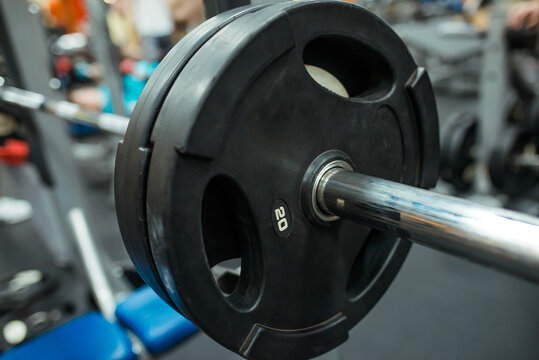Close-up image of a fitness equipment in gym. Barbell in the gym