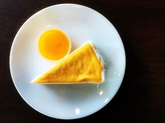 One piece cheesecake with yellow sauce