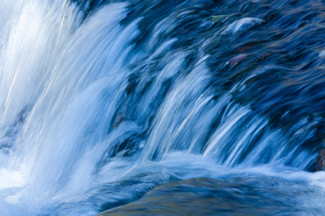 Closeup on descent of small waterfall.