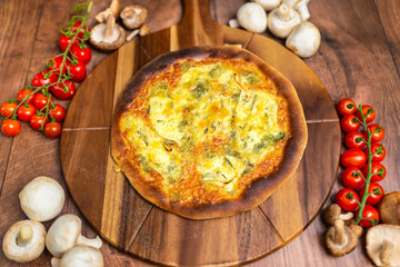Quattro Formaggi/Four Cheese Pizza on a wooden pizza board. Close Up pizza cheese: blue cheese, parmesan, mozzarella, gorgonzola. Concept of homemade pizza with free space for your text/decoration. 