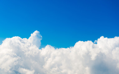 Naklejka na ściany i meble White clouds on blue sky with above aerial view from a plane, nature blue sky background