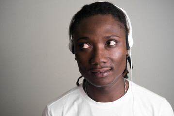 Obraz premium Face of young handsome African man with dreadlocks thinking while listening to music