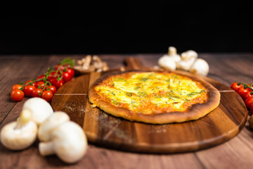 Quattro Formaggi/Four Cheese Pizza on a wooden pizza board. Close Up pizza cheese: blue cheese, parmesan, mozzarella, gorgonzola. Concept of homemade pizza with free space for your text/decoration. 