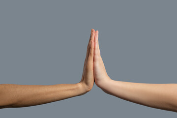 Close-up of people from different races holding palms together