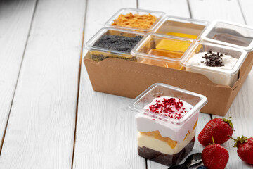 Assortment of delicious dessert boxes on wooden table