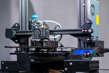 3D plastic printer during work in a factory three dimensional printing. Close-up detail.