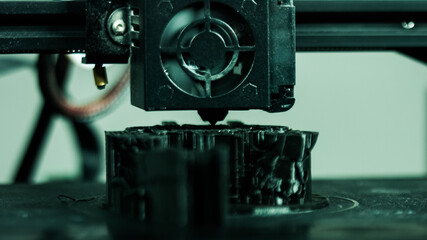 3D plastic printer during work in a factory three dimensional printing. Close-up detail.