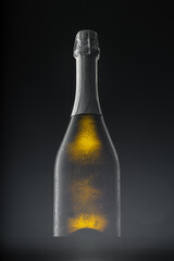 Champagne bottle on black background, copy space