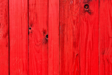 Old grunge wood vertical panels in red.