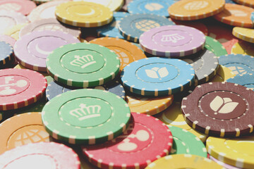 Lot multicolor assorted gambling playing chips surface. Colorful casino chips background. Many...