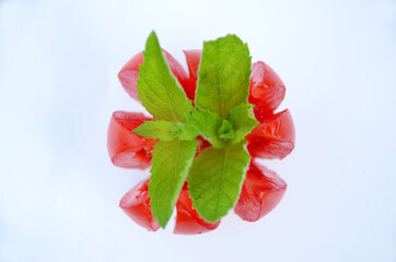 the red tometo with green mint isolated on white background.