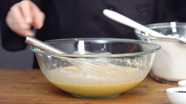 Step by step. Mixing organic ingredients in the glass bowl to bake challah.