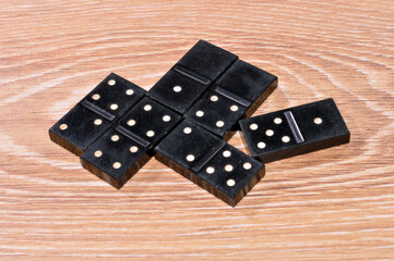 playing dominoes on wooden background