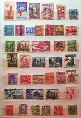 Fototapeta na wymiar many old stamps on a philately catalog page 02.Jul.2020 in Sovata city - Romania