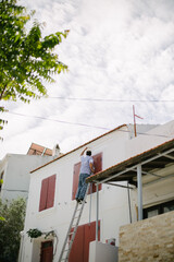 Man painting the wall. The man repairs the house. Repair and renovation works.