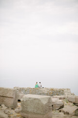 Temple of Athena. Tourist couple. The couple sit side by side in the historical temple, watching the view.