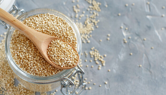 Raw dry white quinoa seeds close up