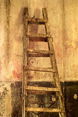 Dirty old staircase in a room with old decrepit walls as background, sepia