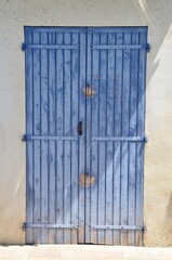 Purple closed wooden shutters in a house wall, Provence, France