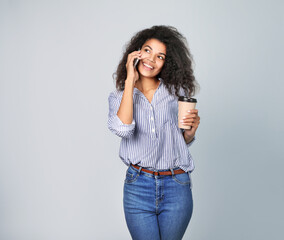 Portrait of a beautiful african woman with coffee and phone on blue background