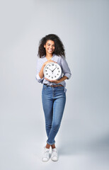 Portrait of a beautiful african woman with a clock on grey background