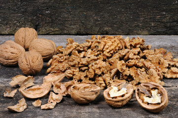 Shelled walnuts on a wooden background. Front view.