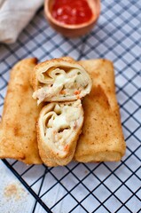 Fried Risoles or Risol Mayo is a typical Indonesian traditional street food made from flour skin, meat and vegetables stuffing inside with mayonnaise and chili sauce. Popular during fasting in Ramadan