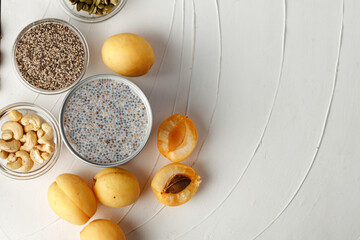 Chia seeds with berry and nuts on white table