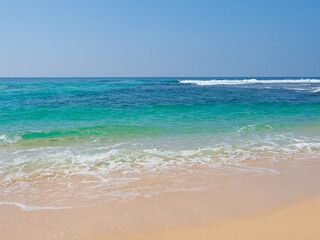 Fototapeta na wymiar Ocean waves run over the beautiful beach on coast of Sri Lanka, Mirissa. Indian ocean.